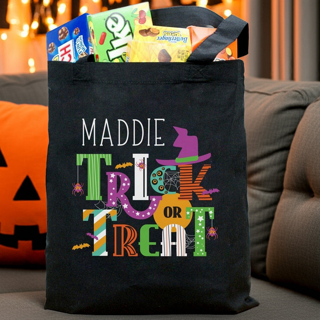 Black trick or treat bag with name Maddie and colorful Halloween graphics filled with candy personalized halloween candy bag