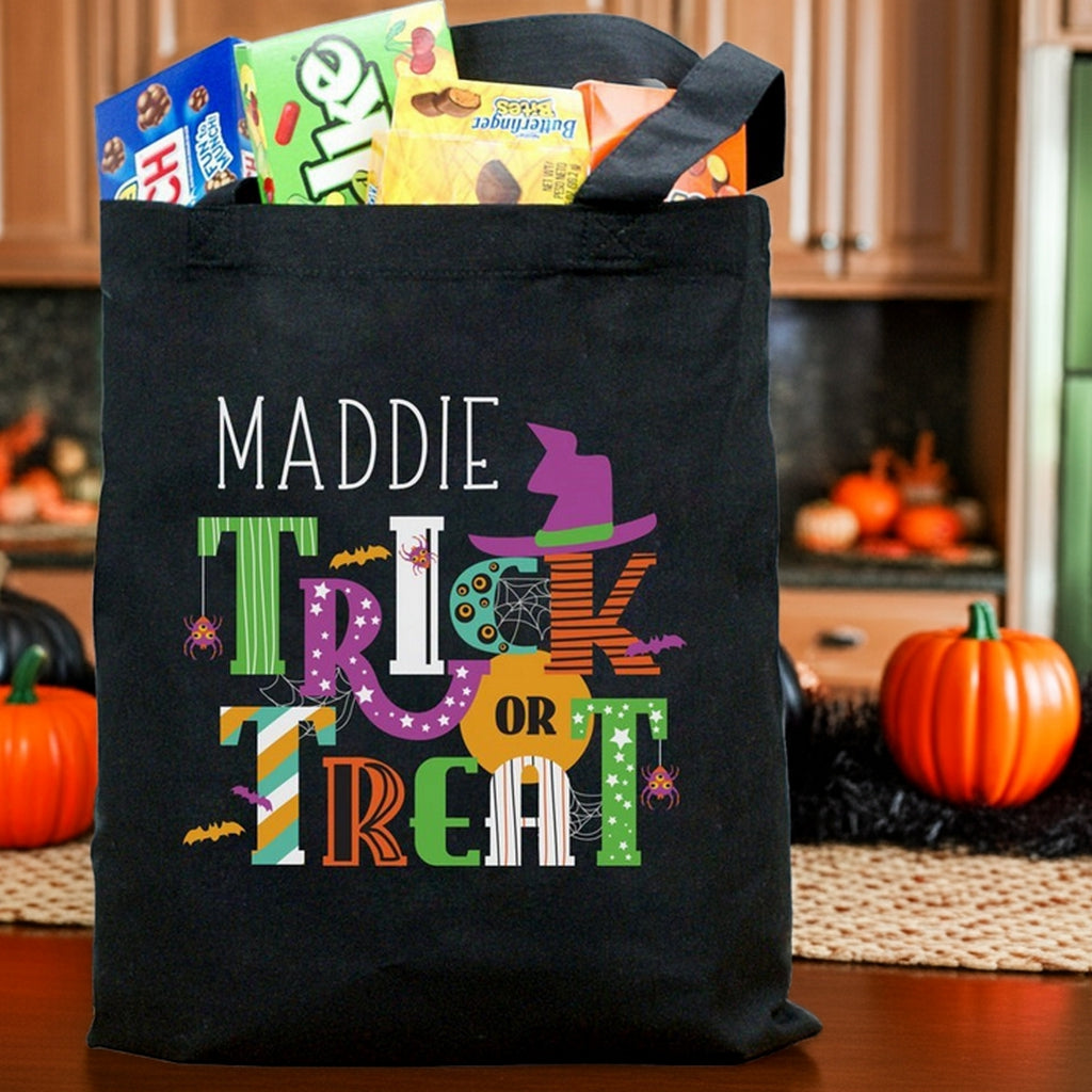 Black canvas trick or treat bag with name Maddie colorful letters witch hat filled with treats personalized halloween candy bag