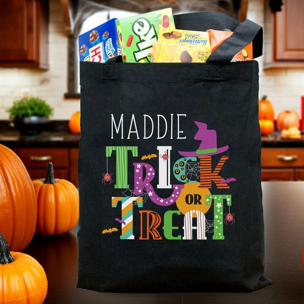 Black personalized halloween candy bag with Maddie name and colorful Trick or Treat design filled with candy