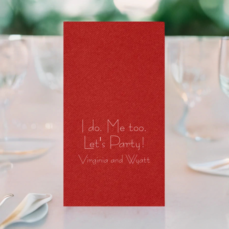 red color displosable linen look hand towel personalized with 3 lines of custom text in white print on wedding reception table