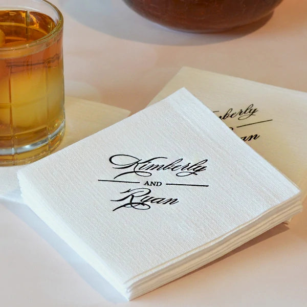 luxury linen like beverage napkins personalzed with bride and groom name custom monogram in black print for wedding reception cocktails