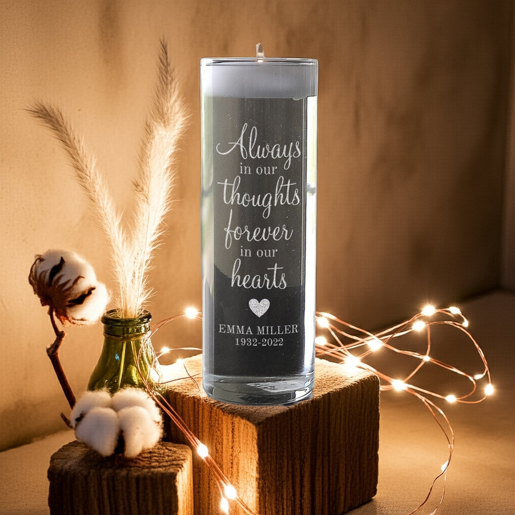 Personalized memorial candle with heartfelt engraved message displayed on wooden blocks with soft lighting