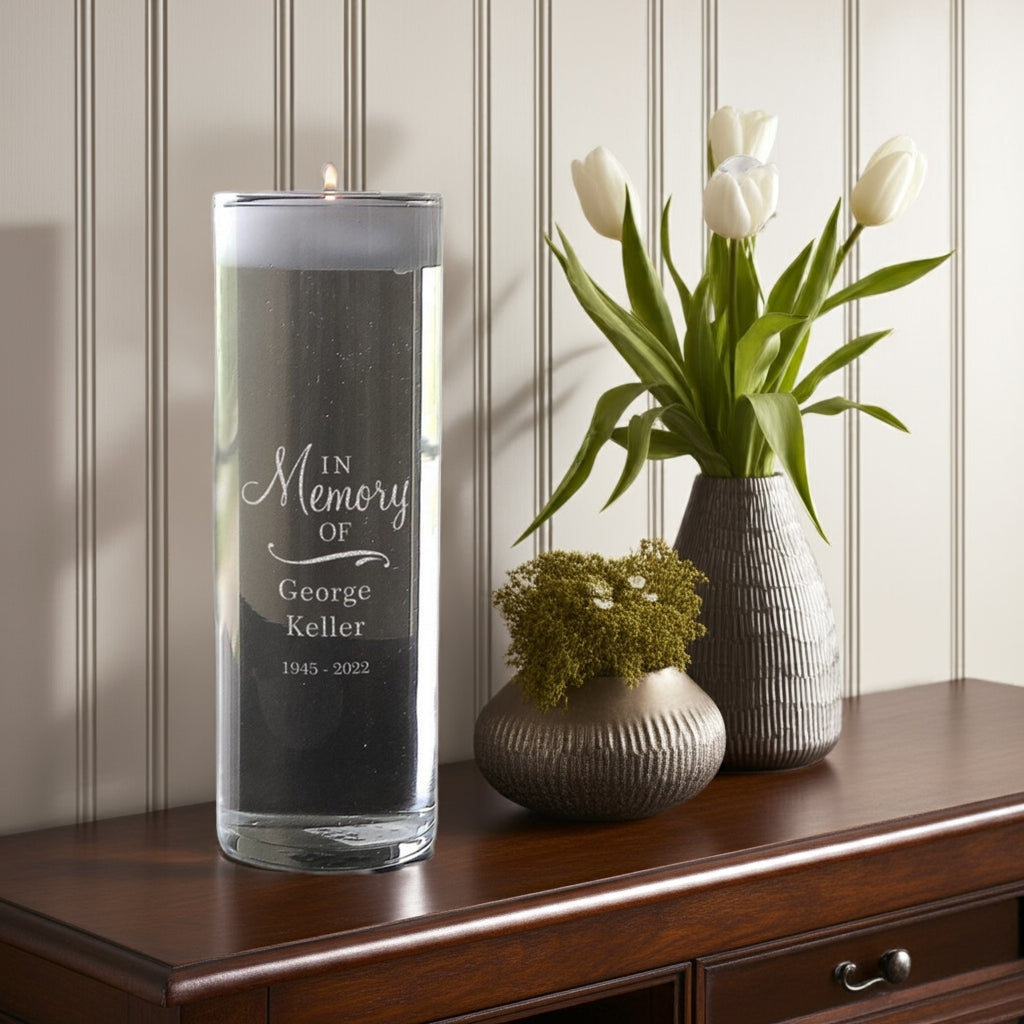 Personalized memorial candle vase with in memory of engraving beside decorative vases with white tulips