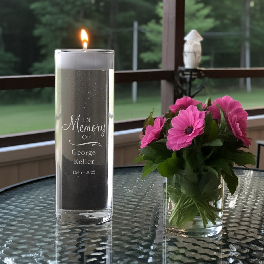 Personalized memorial candle vase with In Memory of George Keller engraving next to pink flowers