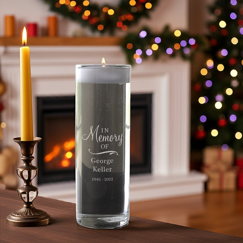 Personalized memorial candle vase with In Memory Of engraving placed on table near a lit candle holder