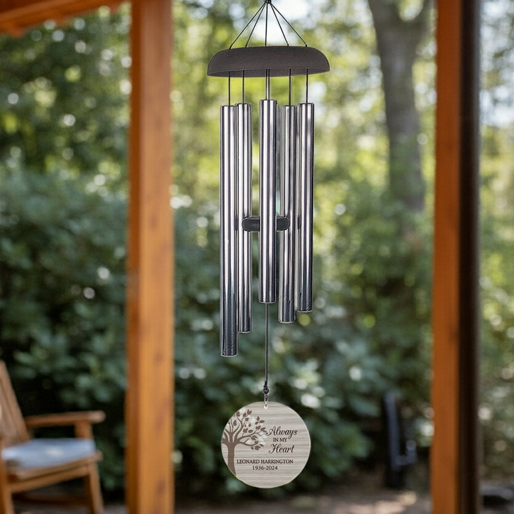 Personalized memorial wind chime with engraved tribute hanging on porch