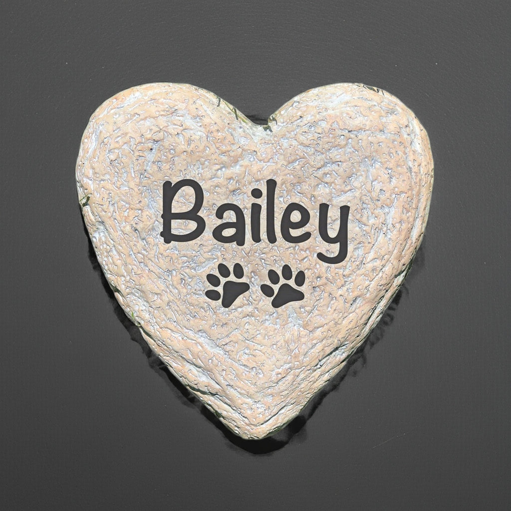Heart-shaped personalized pet memorial stone with name Bailey and paw print design
