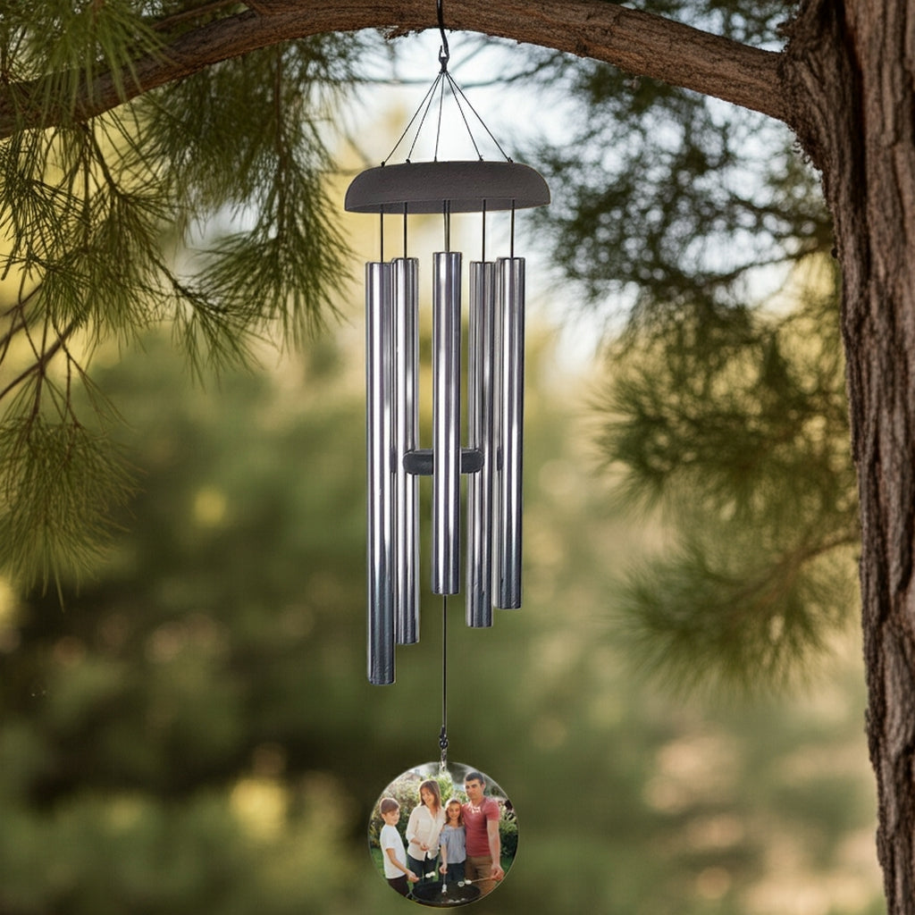 Personalized photo memorial wind chime hanging from tree branch with metal tubes and custom photo pendant