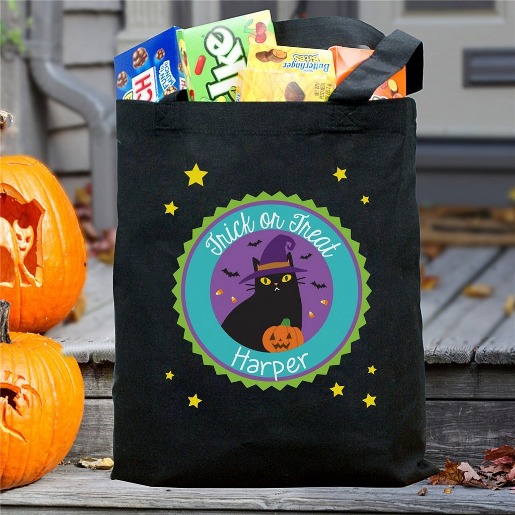 Black Halloween tote with cat and pumpkin design and name Harper personalized trick or treat bag filled with candy