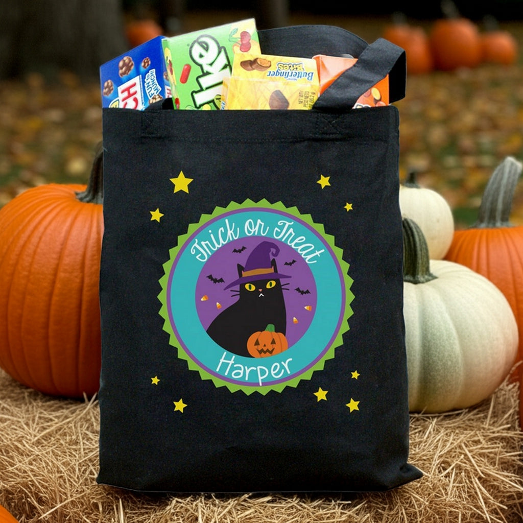 Black Halloween tote with witch cat design and name Harper filled with candy personalized trick or treat bag