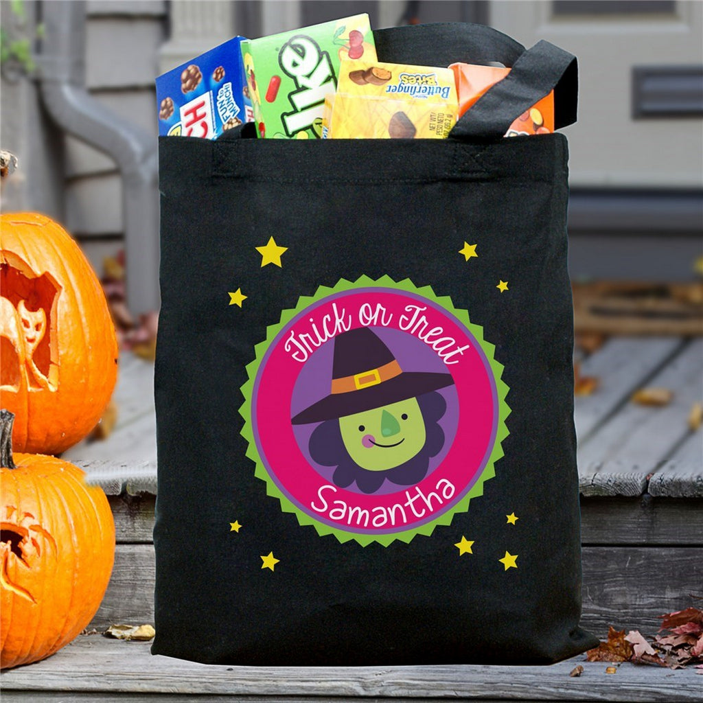 personalized trick or treat bag black canvas with colorful witch design reading Samantha on porch with pumpkins and candy boxes
