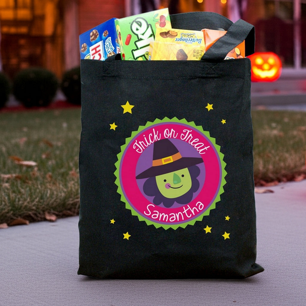 Black Halloween tote bag with green witch badge and name Samantha filled with candy on porch personalized trick or treat bag