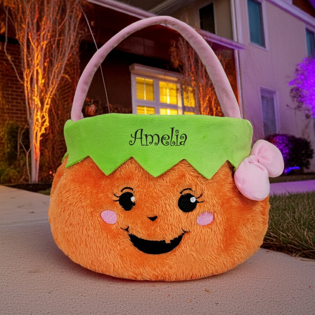 Personalized trick or treat basket with smiling pumpkin face and green top with name Amelia