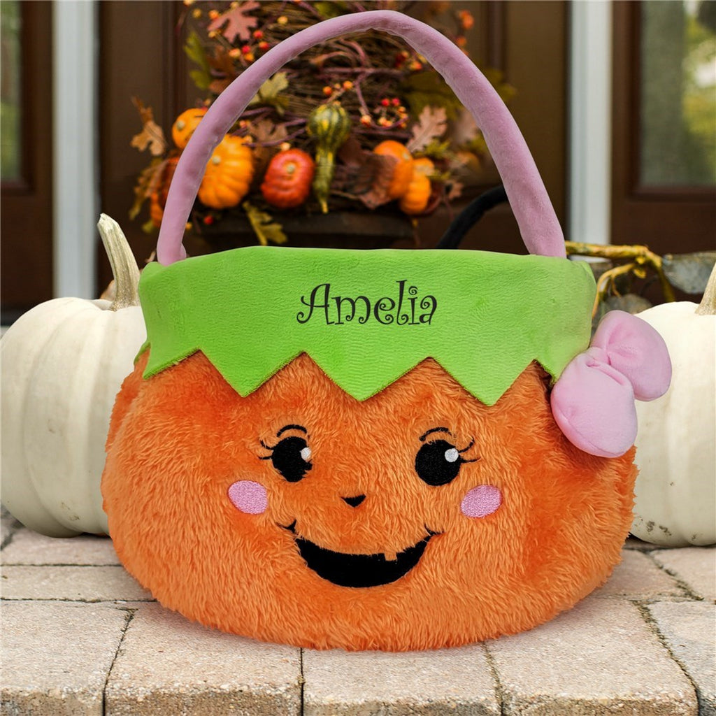 Personalized trick or treat basket in orange plush pumpkin design with green top and purple handle