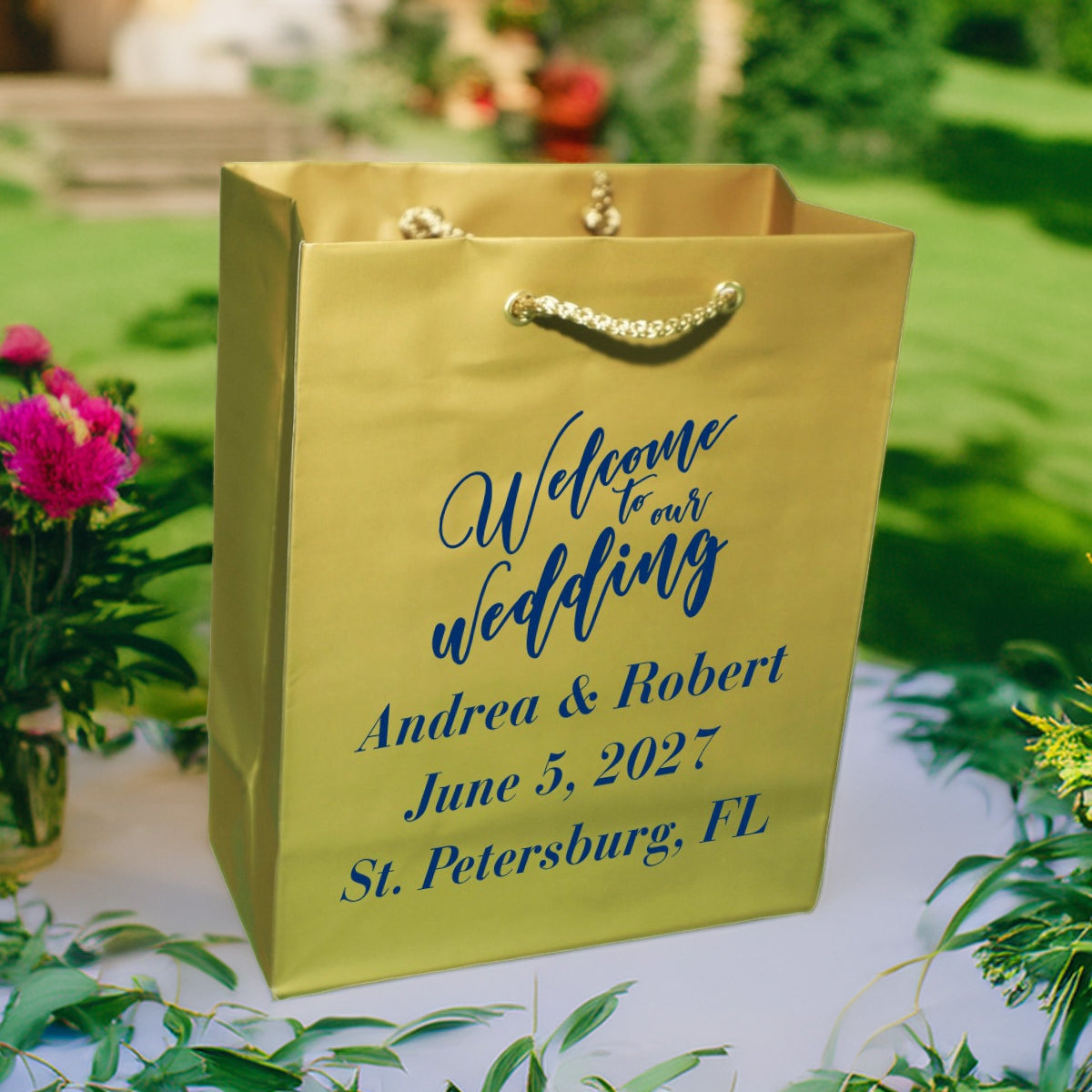 Gold wedding gift bag with rope handles and blue personalized script for Andrea and Robert wedding welcome bags custom printed