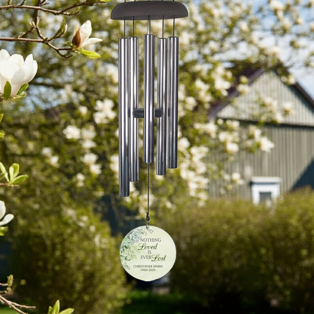 Personalized wind chime memorial with metal tubes and custom engraved pendant hanging outdoors