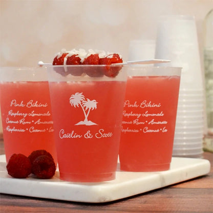 custom printed 12 oz wedding tumbler cups filled with mixed drinks and raspberry garnish