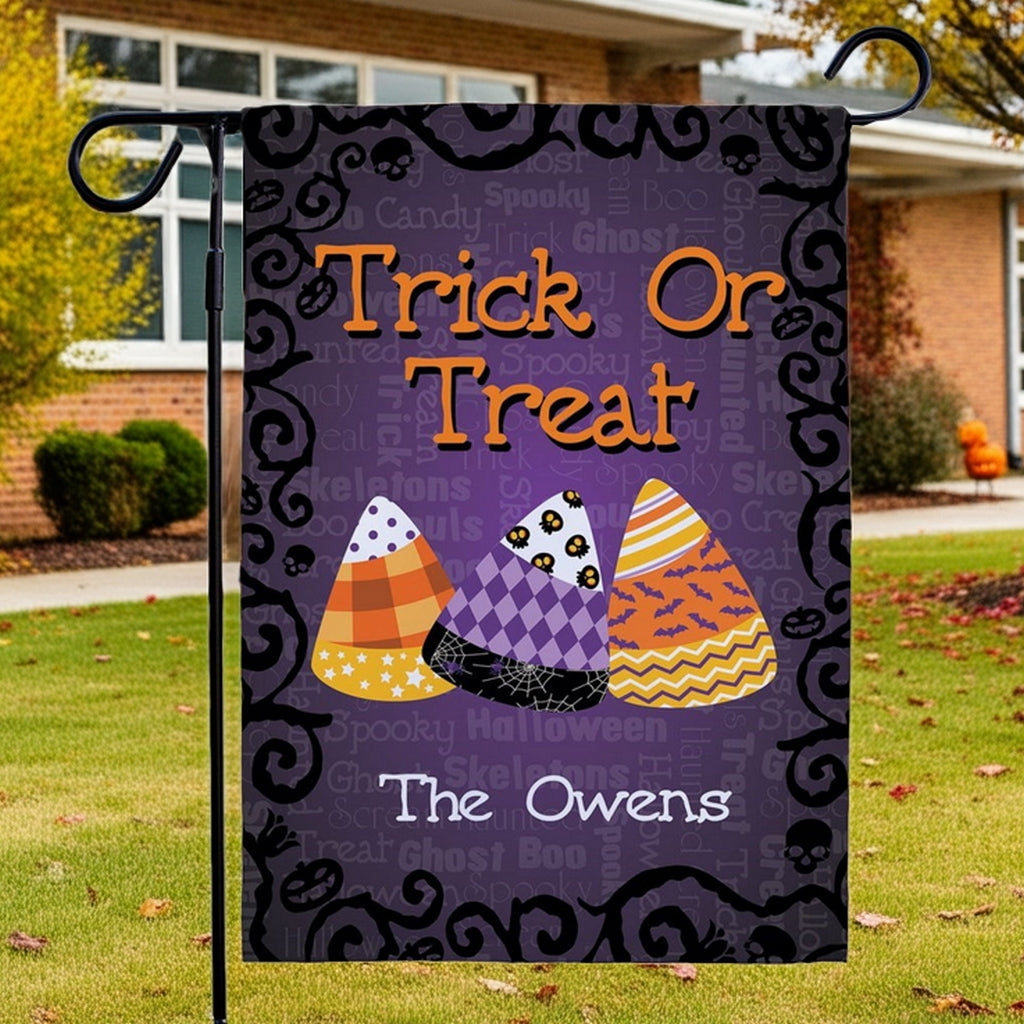 Halloween garden flag purple Trick Or Treat design with candy corn motifs and custom name The Owens
