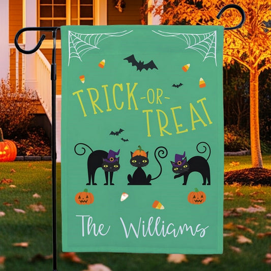 Halloween garden flag green Trick or Treat design with three black cats pumpkins bats and candy corn
