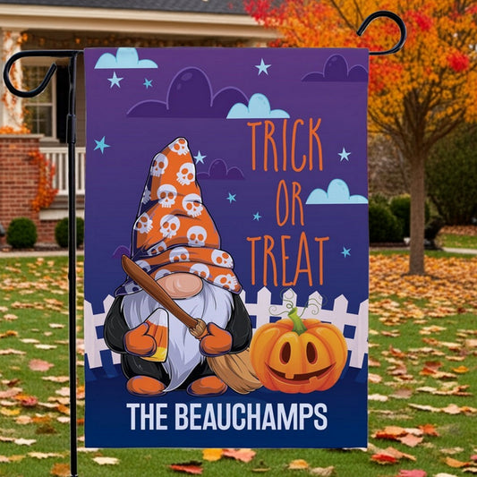Halloween garden flag with gnome in skull witch hat holding broom beside carved pumpkin and Trick or Treat text