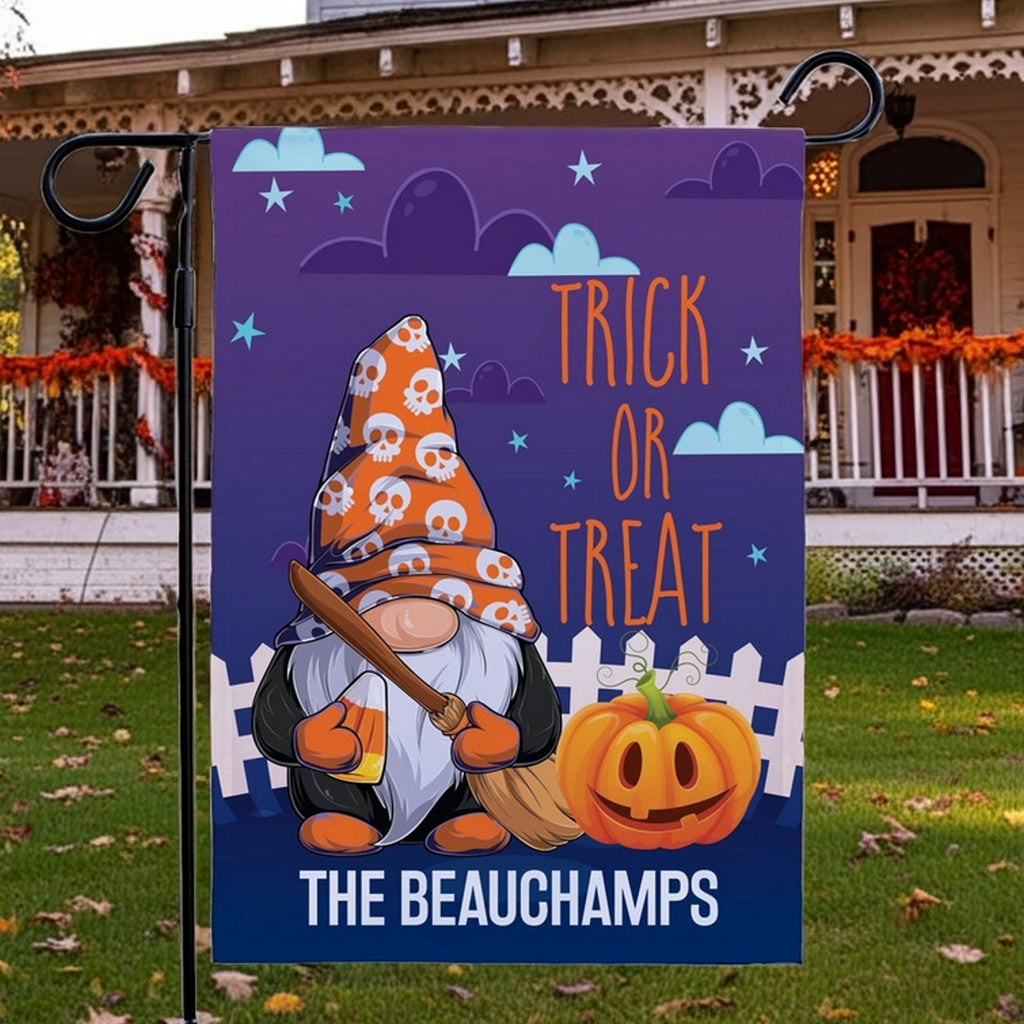Halloween garden flag showing gnome in skull hat with broom and pumpkin and The Beauchamps