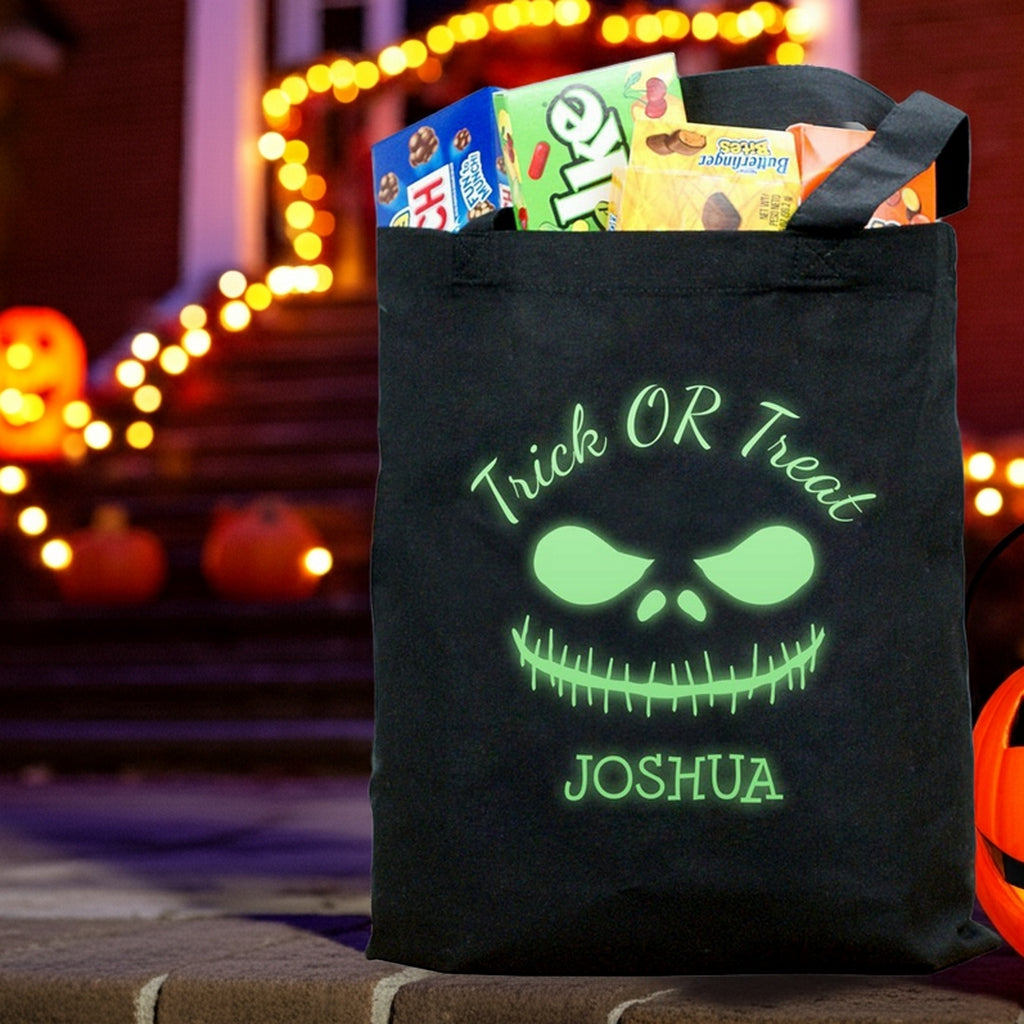 glow in the dark monster personalized trick or treat bag black tote with glowing green face Joshua name and candy on porch