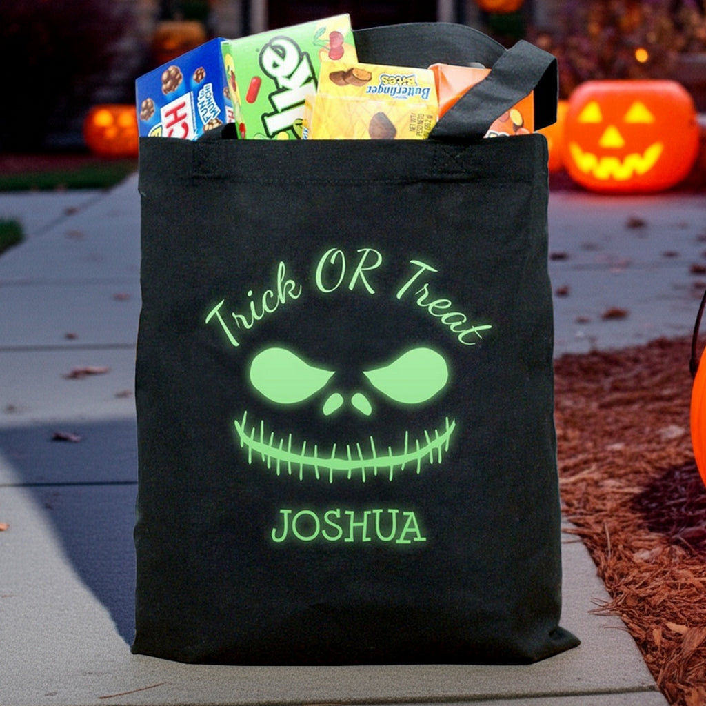 Black Halloween bag with glowing green monster face and name Joshua glow in the dark monster personalized trick or treat bag