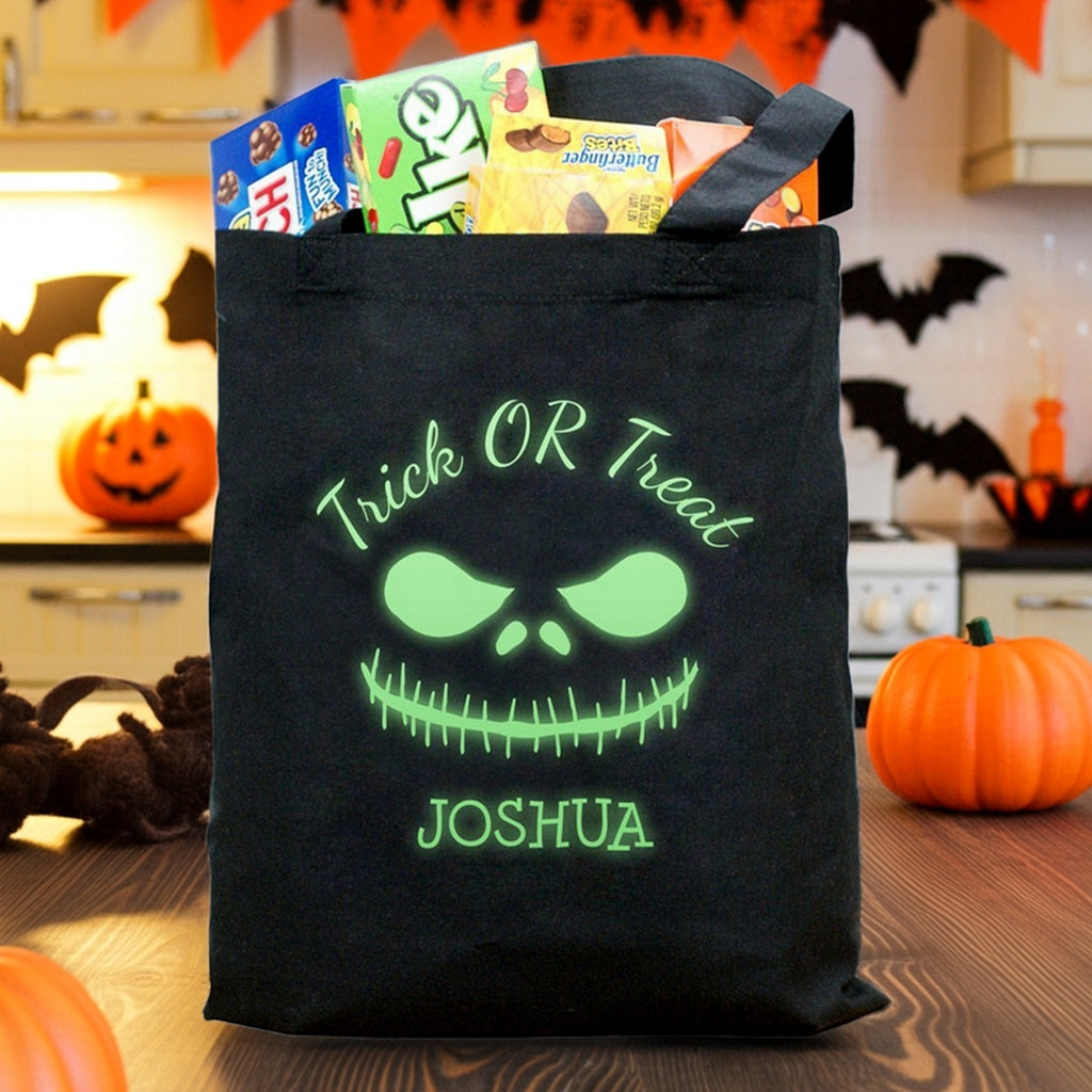 glow in the dark monster personalized trick or treat bag with green glowing face and name Joshua filled with Halloween candy