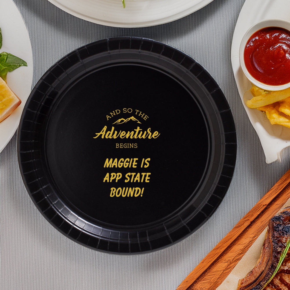 Black paper dinner plate personalized for graduation with "The Adventure Begins" design and text "MAGGIE IS APP STATE BOUND!" in gold print