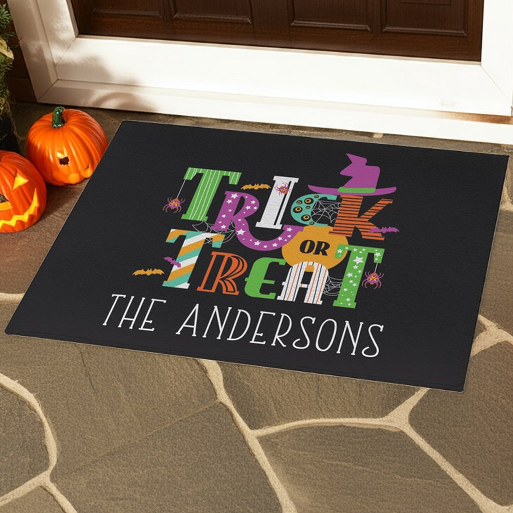 Trick or treat doormat personalized with colorful Halloween design and custom family name