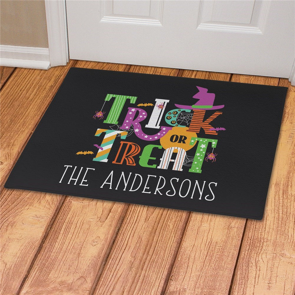 Trick or treat Halloween doormat personalized with colorful Halloween design and custom family name