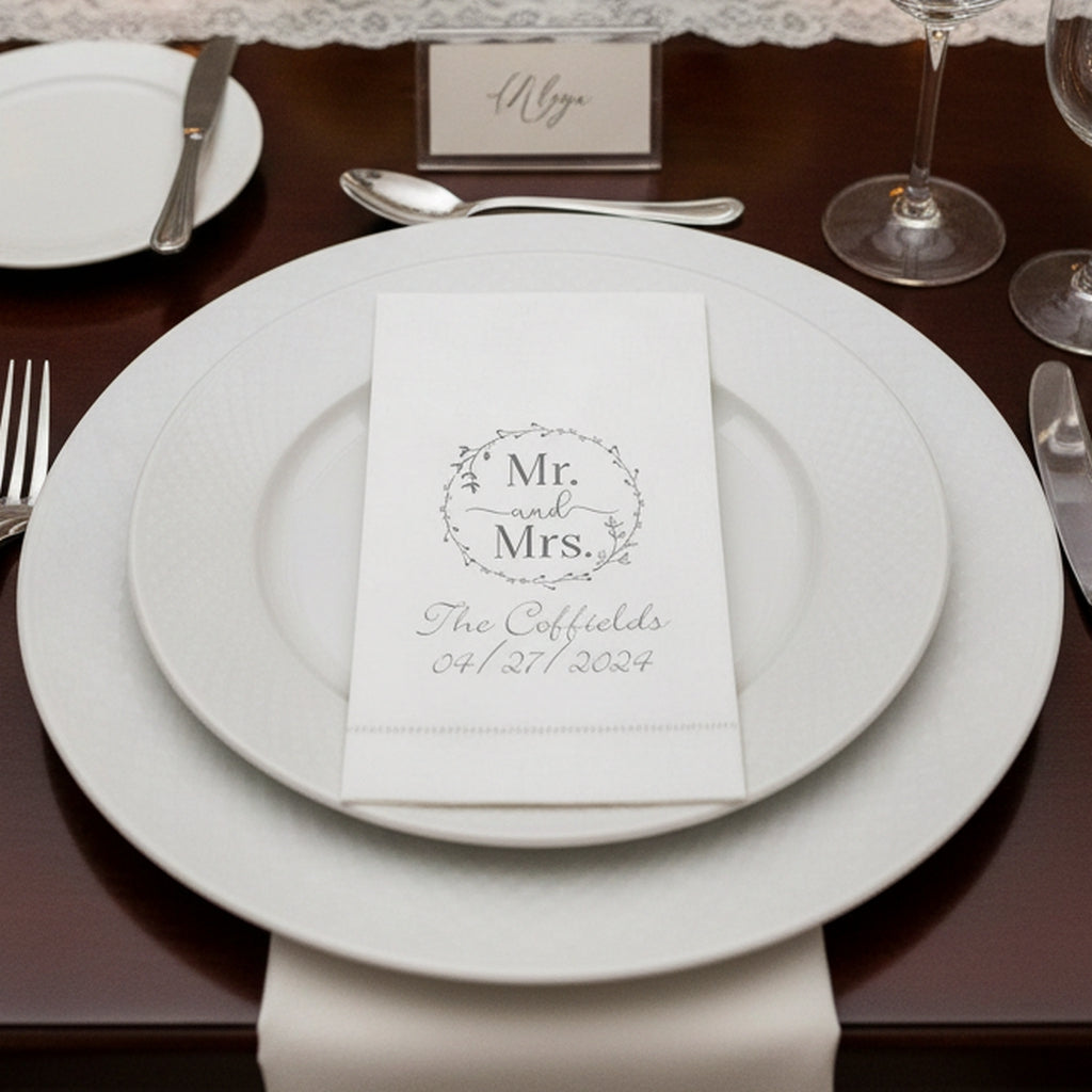 Elegant white linen feel hemstitch guest towel napkins on a wedding table setting