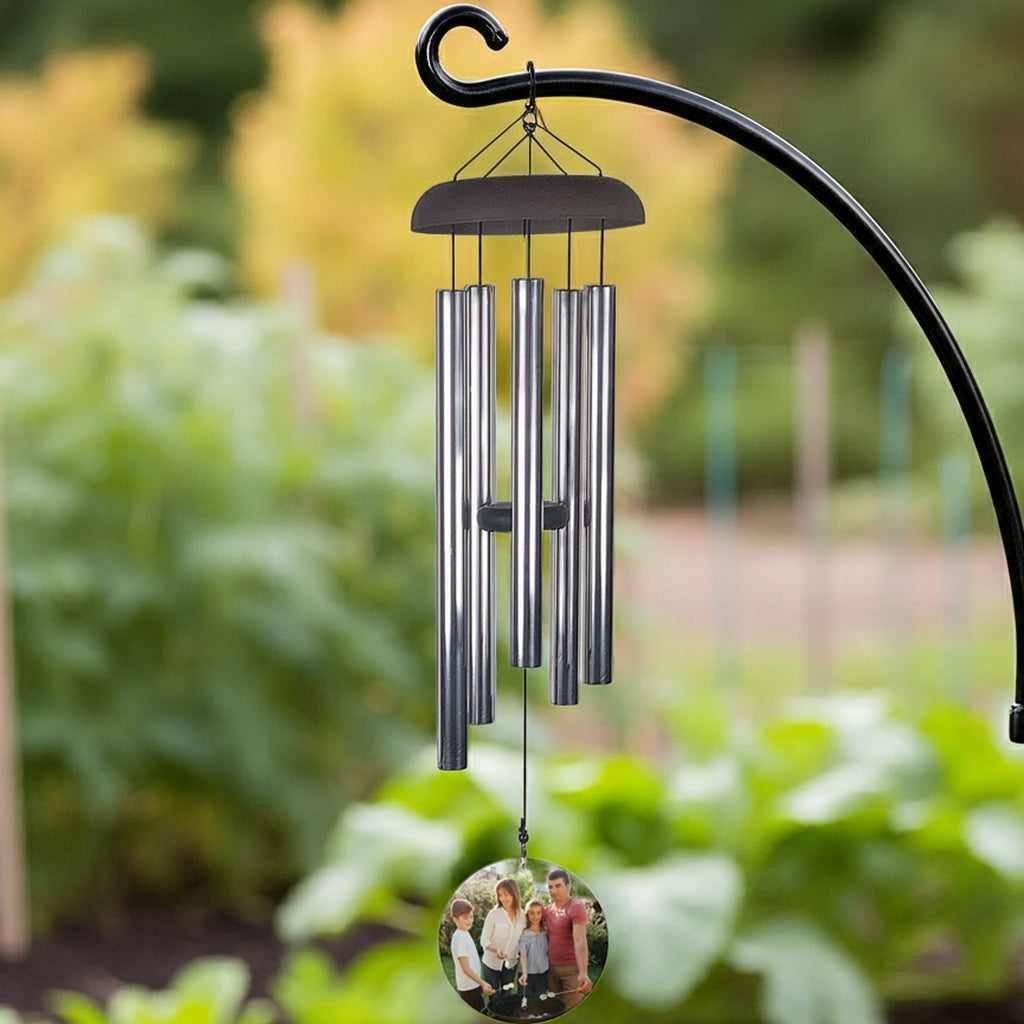 Wind chime personalized with photo wind sail featuring metal tubes hanging outdoors near blooming branches