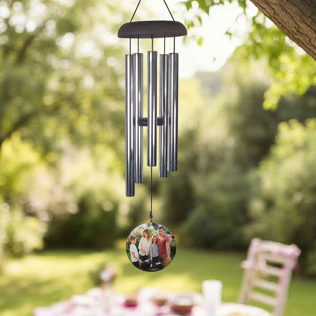 Wind chime personalized with photo wind sail hanging outdoors near window and plants