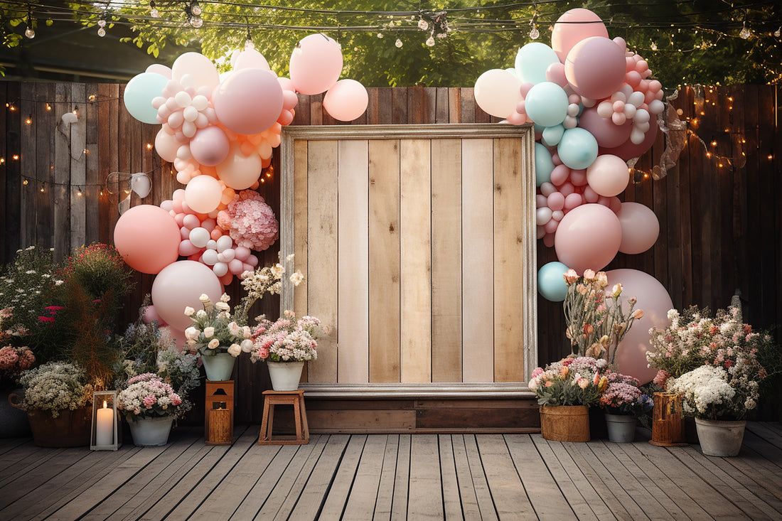 Balloons around a DIY photo booth frame made of wood in outdoor setting