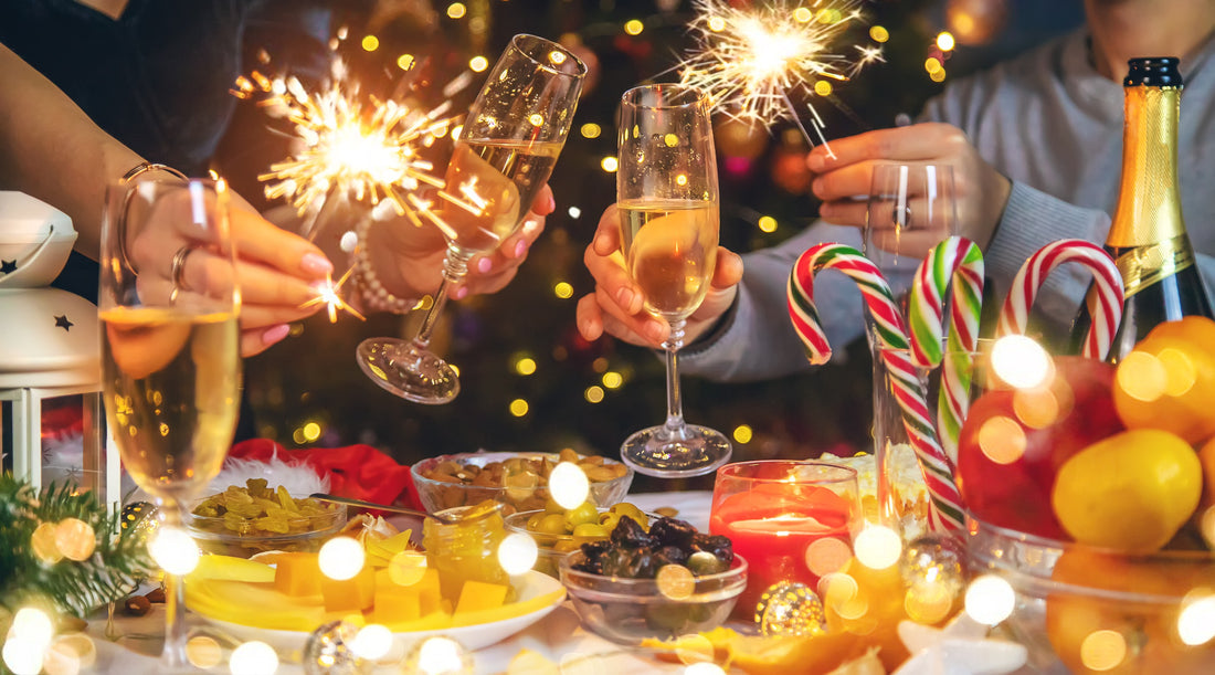 Your people toasint with champagne in hand against the background of the Christmas tree at a Chritmas holiday party