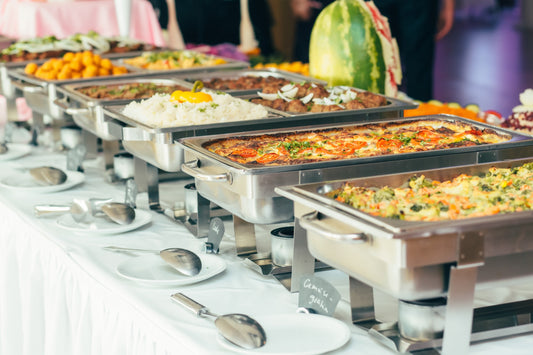 Steam trays filled with food at a self catered wedding reception