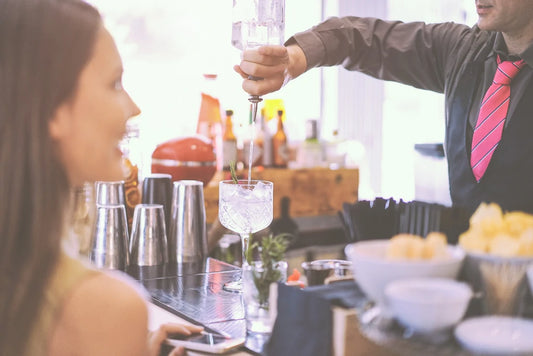 Guest being served alcoholic drink at wedding reception bar
