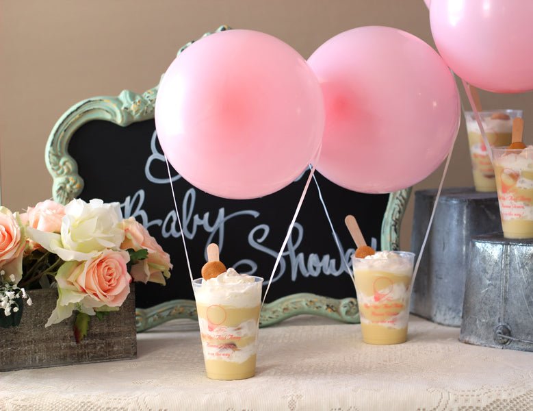 Personalized dessert cups with balloons on baby shower dessert table