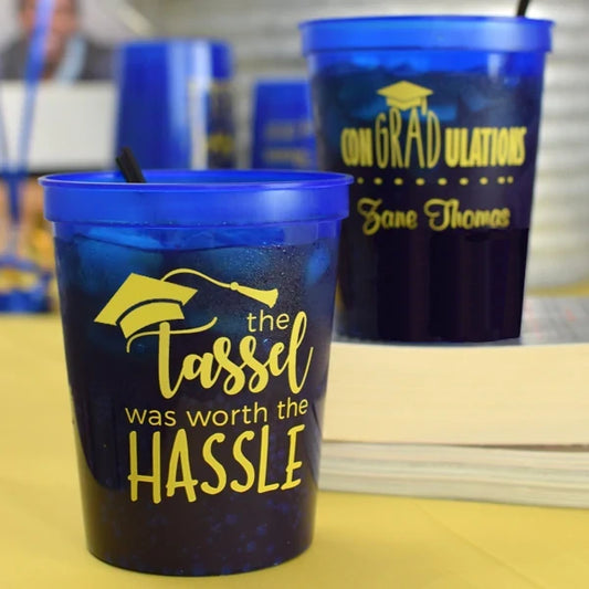 16 Oz. Personalized Plastic Graduation Stadium Cups with blue lids and yellow graduation-themed designs
