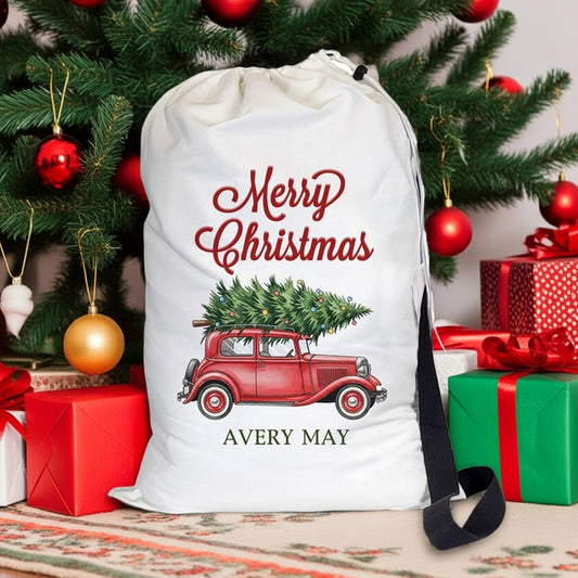 Santa gift sack featuring a vintage red truck with a Christmas tree and festive lettering