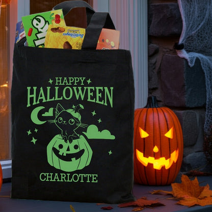 Black Halloween tote with green cat in pumpkin personalized trick or treat bag design named Charlotte filled with candy