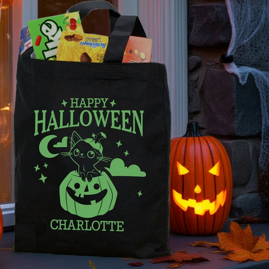 Black Halloween tote with green cat in pumpkin personalized trick or treat bag design named Charlotte filled with candy