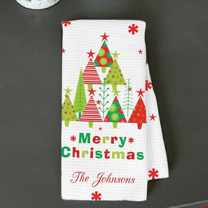 Customized kitchen towel featuring festive trees and bright color personalized with family name