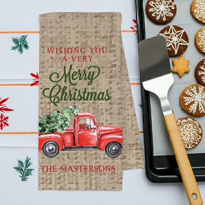 Christmas kitchen towel personalized with name featuring a red truck and festive greetings for the holiday season