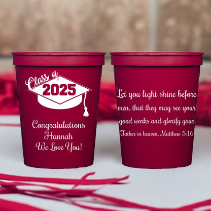 Class of 2025 Graduation Cap clip art personalized on maroon color plastic cups in white print for grad party cup favors