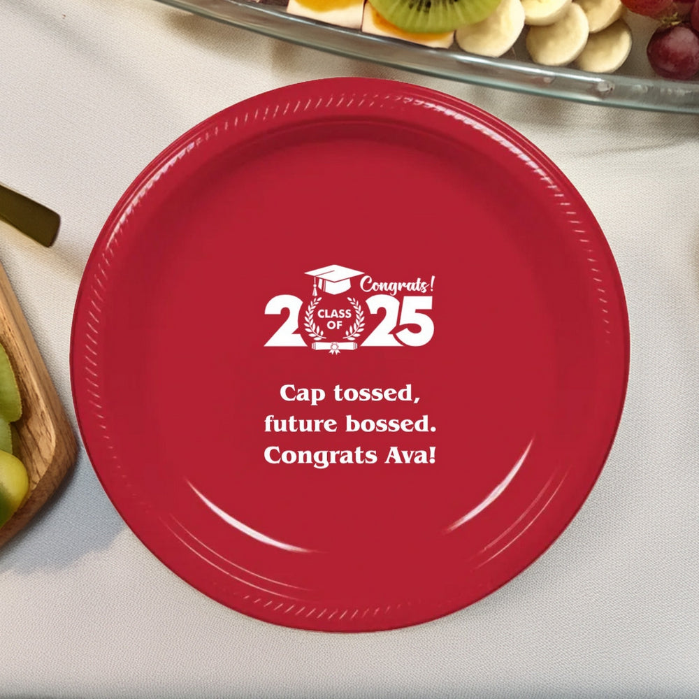 This vibrant red graduation dinner plate personalized in white print celebrates the Class of 2025 with a heartfelt message for the graduate. Featuring a classic graduation cap and the empowering words "Cap tossed, future bossed," it’s a perfect keepsake for a memorable graduation dinner. Surrounded by fresh fruits, this plate sets the tone for a festive and inspiring celebration of new beginnings!