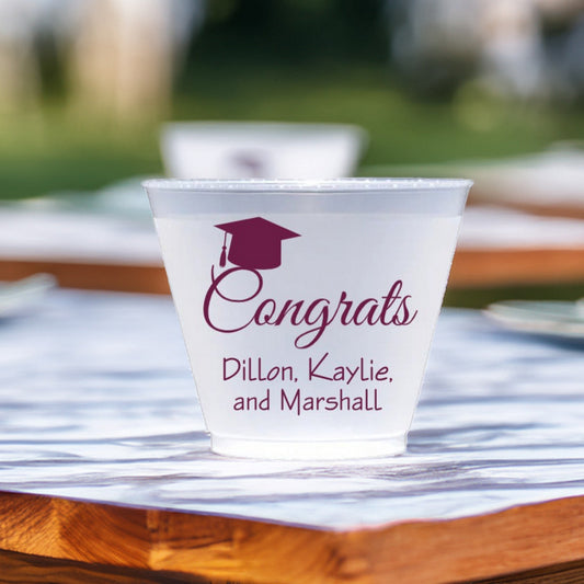 Frosted plastic graduation squat cup personalized with "Congrats Grad Cap" design and graduate names in Burgundy print