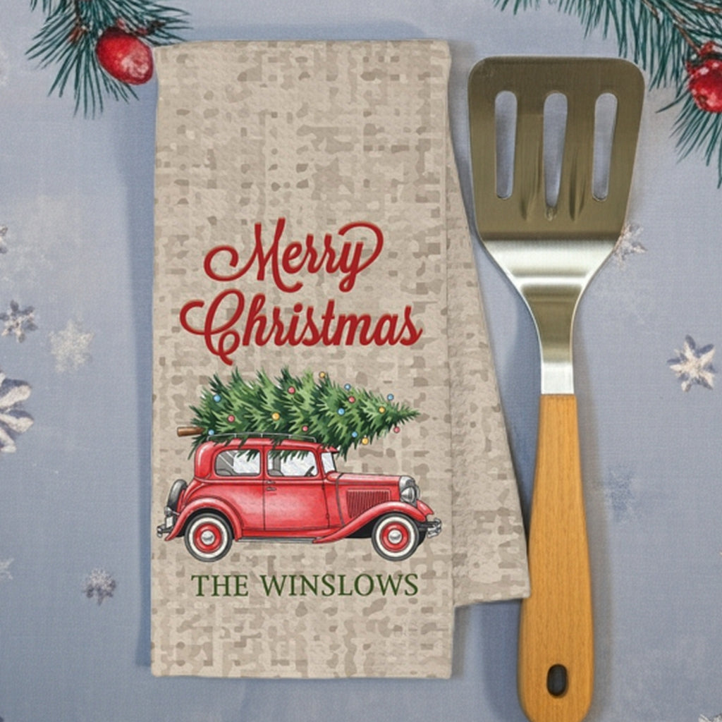 Christmas kitchen towel featuring a red vintage car with a Christmas tree and festive design personalized with family name