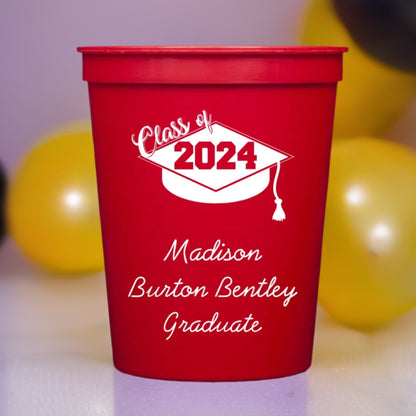 a red color graduation cup custom printed with class of 2024 grad cap design and 3 lines of text in white print